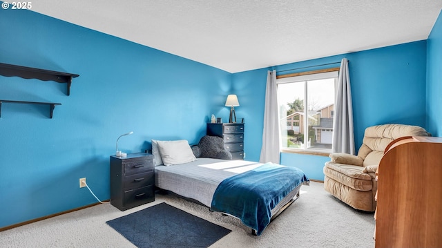 carpeted bedroom with a textured ceiling and baseboards