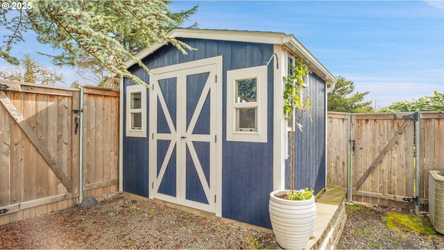 view of shed with a fenced backyard