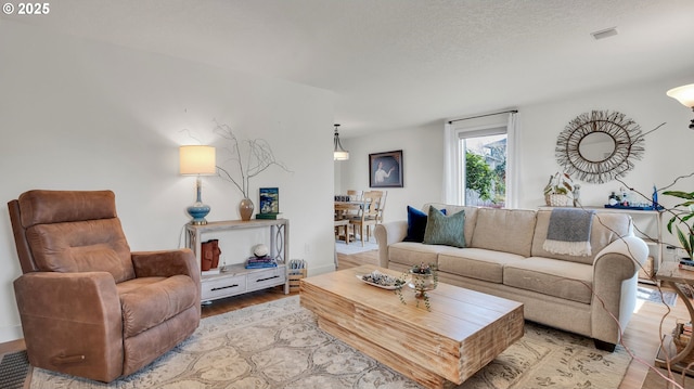 living room with light wood-type flooring and visible vents