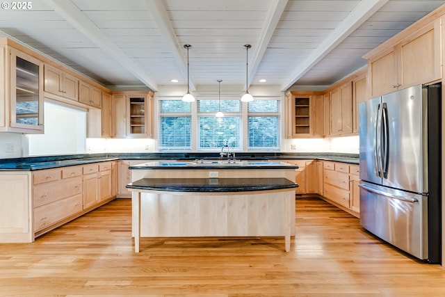 kitchen featuring pendant lighting, stainless steel fridge, light brown cabinetry, and light hardwood / wood-style floors