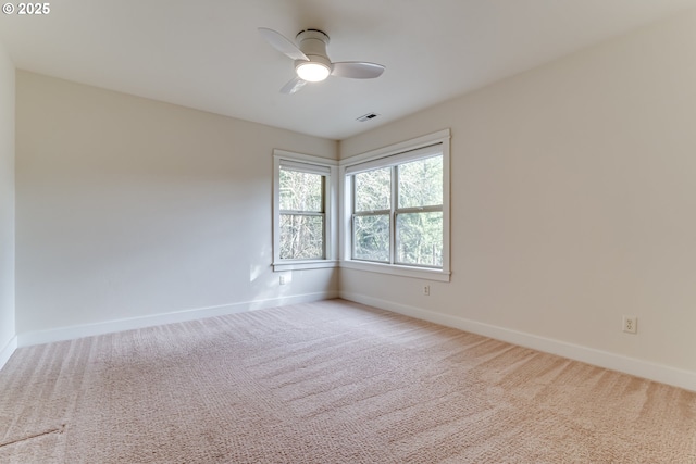 empty room featuring light carpet and ceiling fan