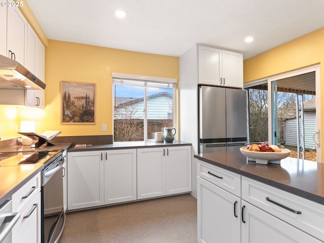 kitchen featuring a healthy amount of sunlight, stainless steel appliances, and white cabinets