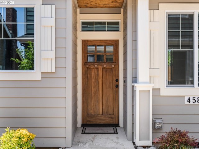4585 N Haight Ave, Portland, OR 97217 - foyer entrance with an AC wall unit, wood finished floors, a decorative wall, and a wainscoted wall