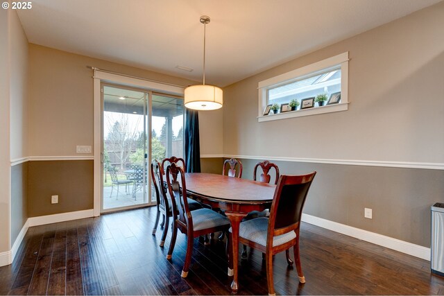 dining area with dark hardwood / wood-style floors and a healthy amount of sunlight