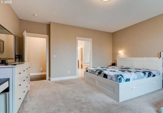 carpeted bedroom featuring connected bathroom