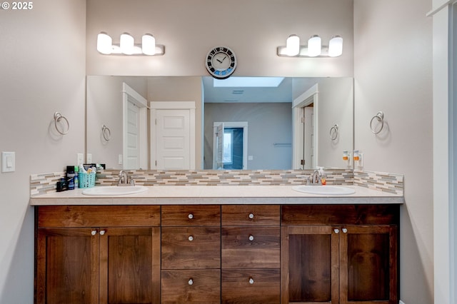 bathroom featuring vanity and decorative backsplash