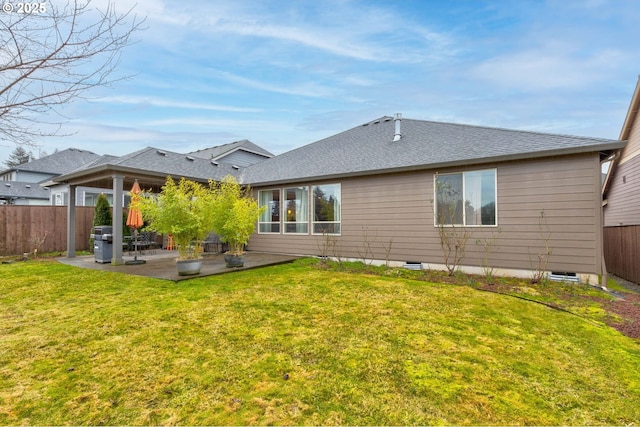 back of property with a yard and a patio area