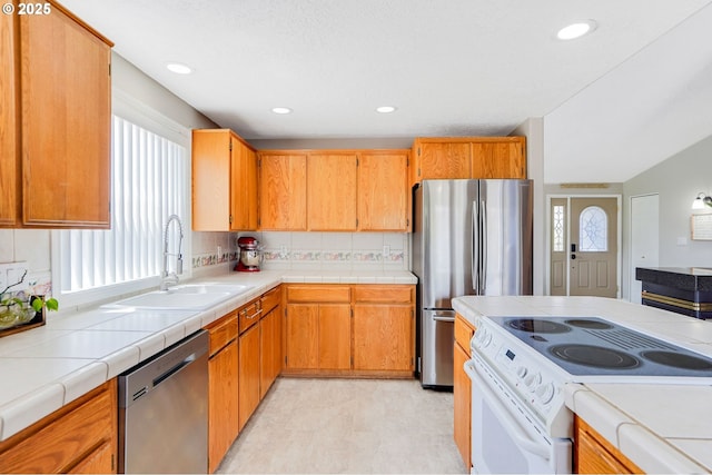 4870 Dorrance Loop NE, Salem, OR 97305 - kitchen with appliances with stainless steel finishes, recessed lighting, tile counters, and brown cabinetry