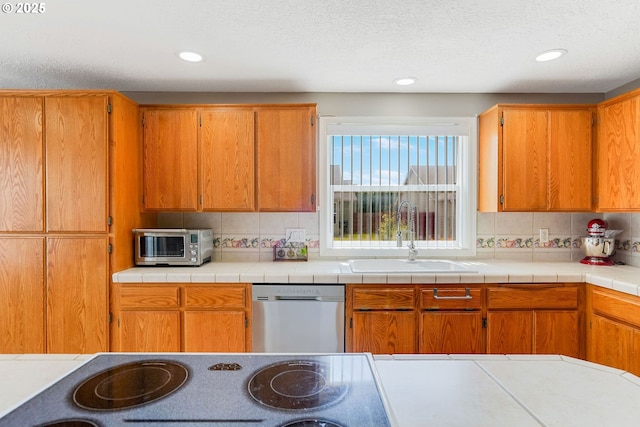 4870 Dorrance Loop NE, Salem, OR 97305 - kitchen featuring stainless steel appliances, tasteful backsplash, recessed lighting, brown cabinets, and light countertops