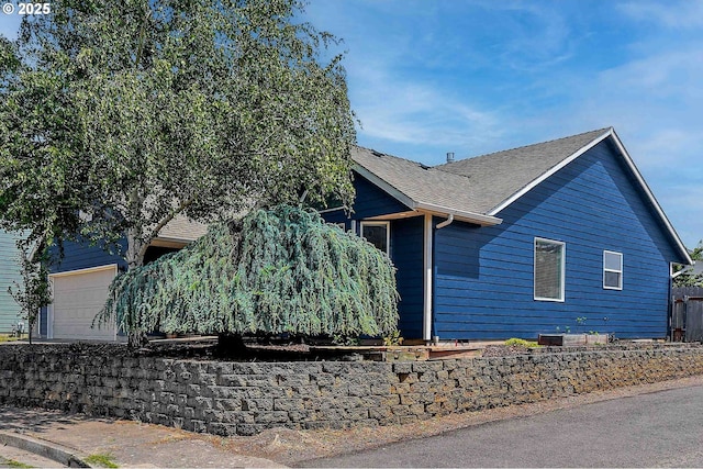 4870 Dorrance Loop NE, Salem, OR 97305 - view of side of home with roof with shingles and an attached garage
