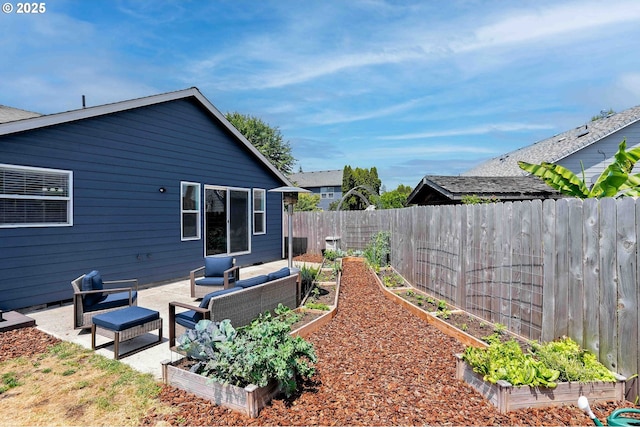 4870 Dorrance Loop NE, Salem, OR 97305 - rear view of property with a vegetable garden, outdoor lounge area, and a fenced backyard