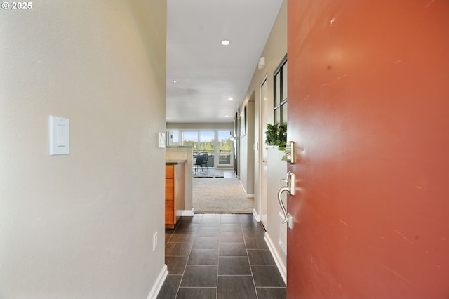 corridor featuring baseboards and recessed lighting