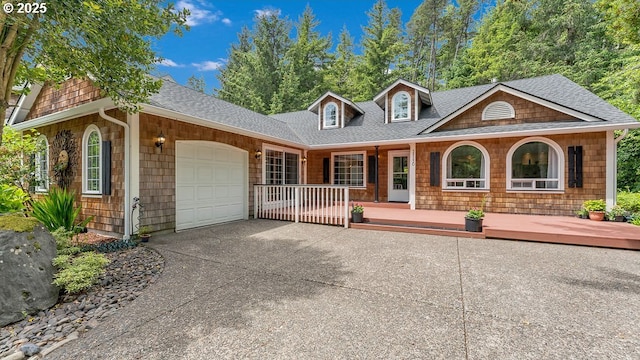 35130 Ponderosa Loop, Manzanita, OR 97130 - view of front of property featuring covered porch, a garage, roof with shingles, and driveway