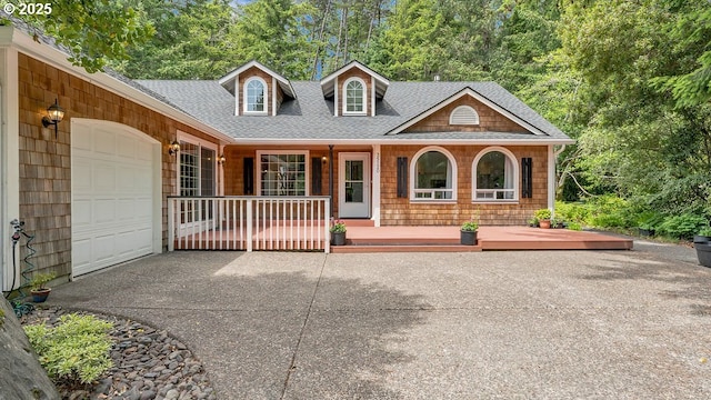 35130 Ponderosa Loop, Manzanita, OR 97130 - view of front facade featuring covered porch, driveway, a garage, and a shingled roof
