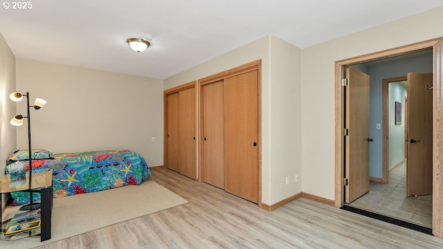 35130 Ponderosa Loop, Manzanita, OR 97130 - unfurnished bedroom with light wood finished floors and two closets