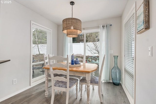 dining space with wood finished floors and baseboards