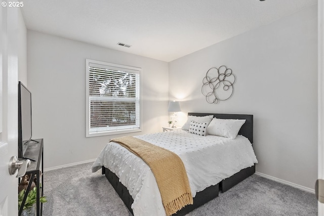 bedroom featuring carpet floors, visible vents, and baseboards