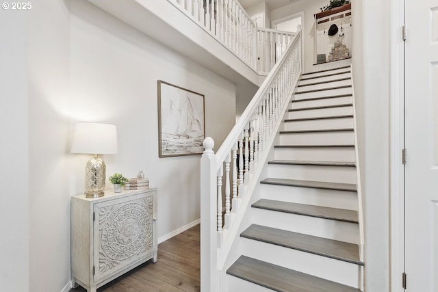 stairs with baseboards and wood finished floors