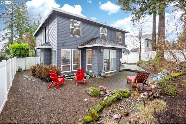 back of property featuring a fenced backyard and a patio