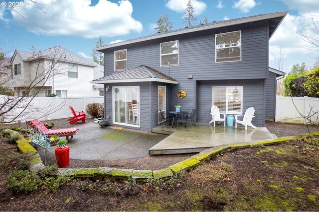 back of property featuring a fenced backyard and a patio