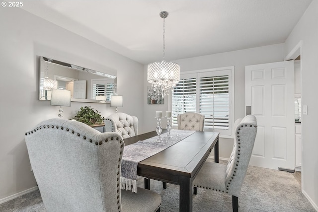 carpeted dining space featuring an inviting chandelier and baseboards