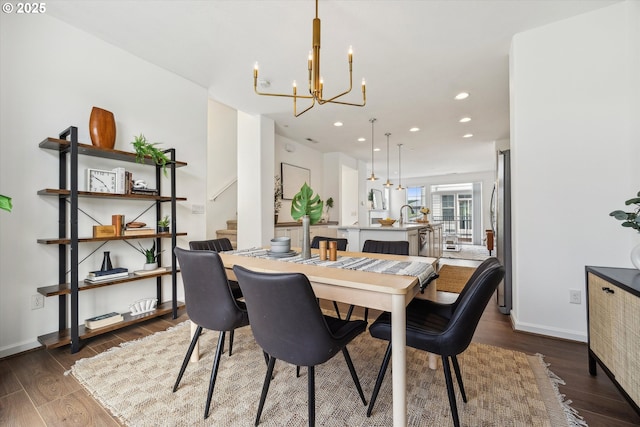 dining room with a chandelier, dark wood-style floors, recessed lighting, baseboards, and stairs