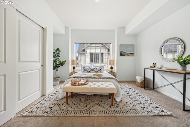 carpeted bedroom featuring baseboards