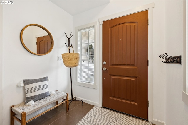 tiled entryway featuring baseboards