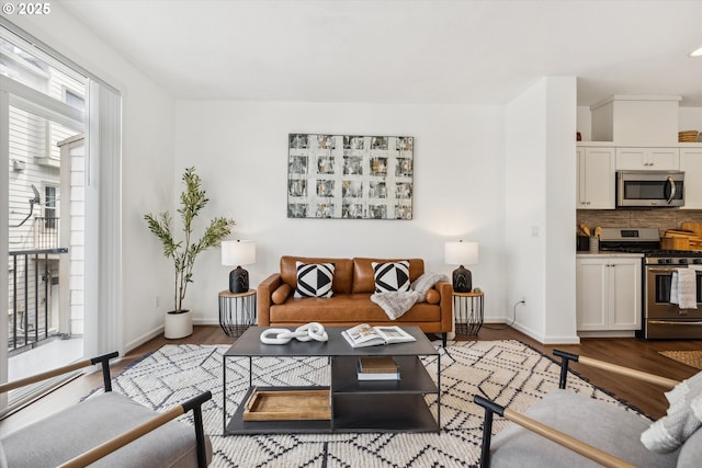 living room featuring wood finished floors and baseboards