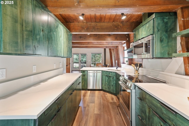 10056 Beach Dr, Birkenfeld, OR 97016 - kitchen with green cabinets, appliances with stainless steel finishes, wood finished floors, wood ceiling with exposed beams, and a sink