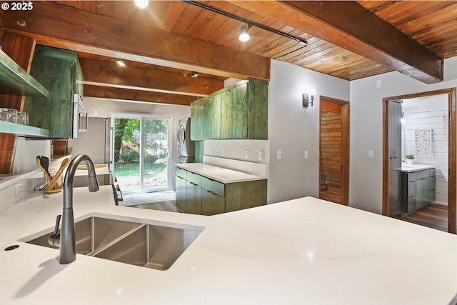 10056 Beach Dr, Birkenfeld, OR 97016 - kitchen with a sink, wood ceiling with exposed beams, light countertops, dark wood-style floors, and green cabinets
