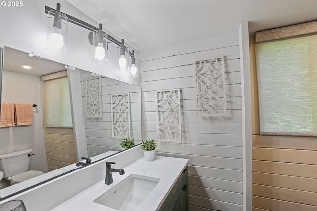 10056 Beach Dr, Birkenfeld, OR 97016 - bathroom with toilet, vanity, and wood walls