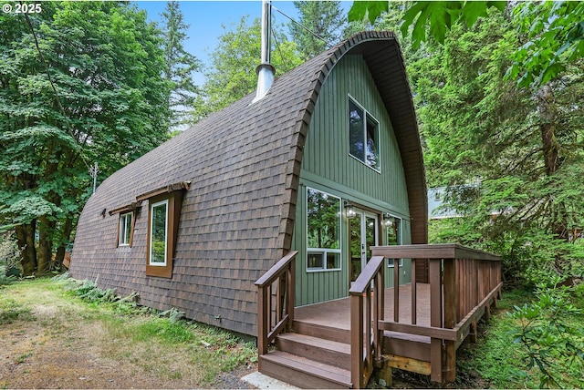 10056 Beach Dr, Birkenfeld, OR 97016 - view of front facade featuring a deck and roof with shingles
