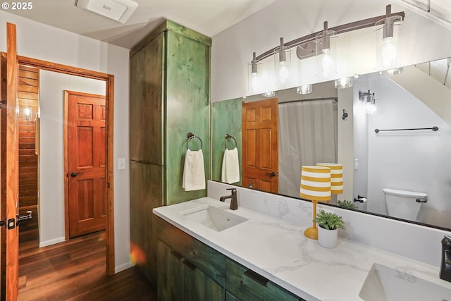 10056 Beach Dr, Birkenfeld, OR 97016 - full bathroom with wood finished floors, double vanity, toilet, and curtained shower