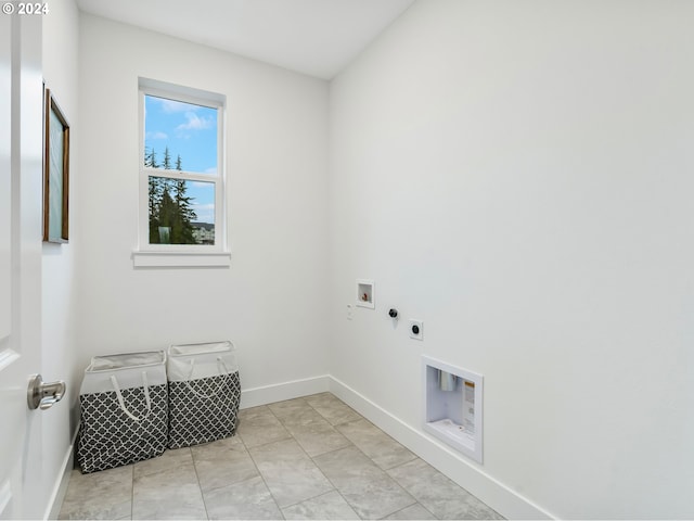 washroom with gas dryer hookup, light tile patterned floors, hookup for a washing machine, and hookup for an electric dryer