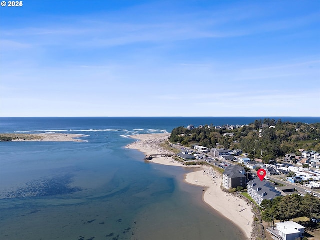 drone / aerial view featuring a water view and a beach view