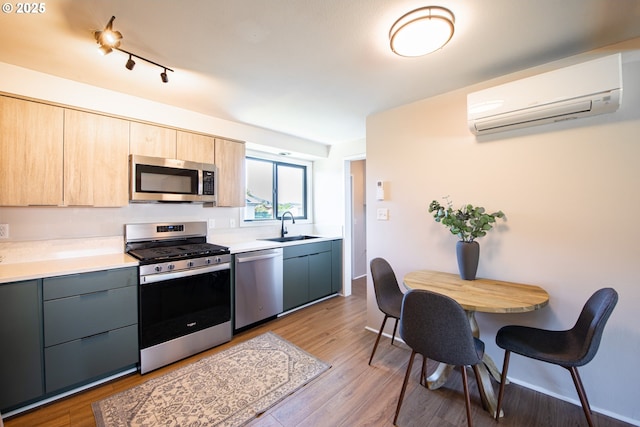 288 51st St, Springfield, OR 97478 - kitchen with light brown cabinetry, a sink, a wall mounted air conditioner, light countertops, and appliances with stainless steel finishes