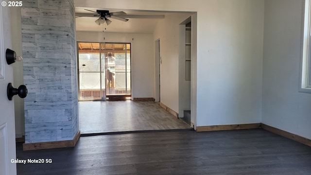 unfurnished room featuring ceiling fan, baseboards, and wood finished floors