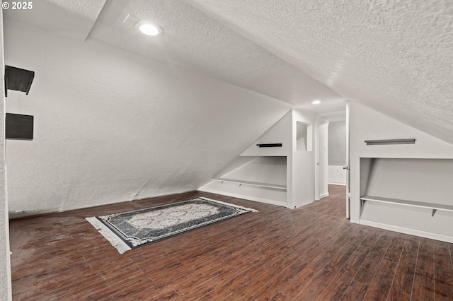 406 W C St, Rainier, OR 97048 - bonus room with a textured ceiling, wood finished floors, vaulted ceiling, recessed lighting, and baseboards
