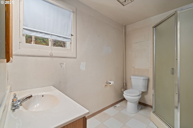 406 W C St, Rainier, OR 97048 - bathroom featuring a stall shower, toilet, vanity, baseboards, and tile patterned floors