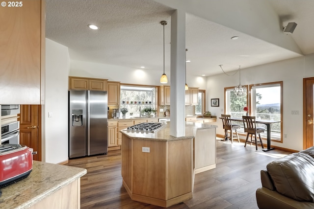 kitchen with recessed lighting, appliances with stainless steel finishes, a center island, and dark wood-style flooring