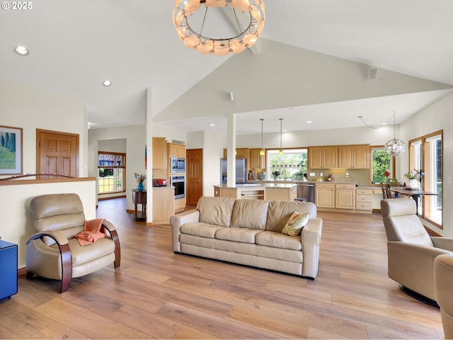 living area with light wood-type flooring, recessed lighting, and high vaulted ceiling