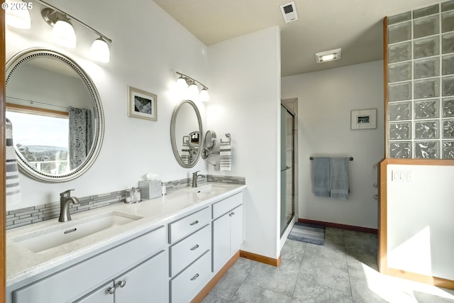 full bath with visible vents, a shower with shower door, and a sink