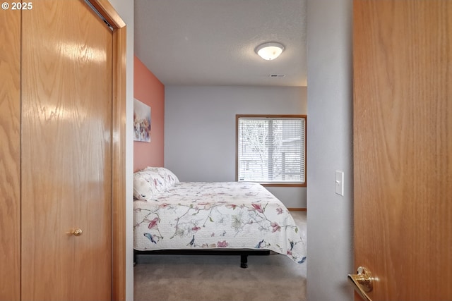 carpeted bedroom featuring visible vents