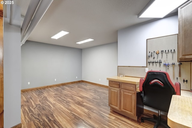 office featuring light wood-style floors and baseboards