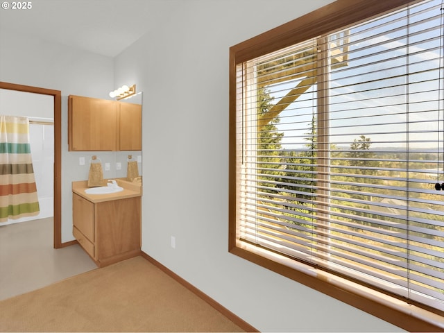 full bathroom featuring vanity, baseboards, and shower / bath combo
