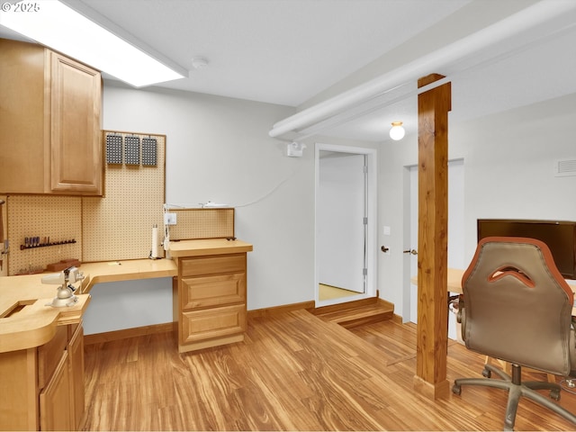home office with baseboards and light wood finished floors