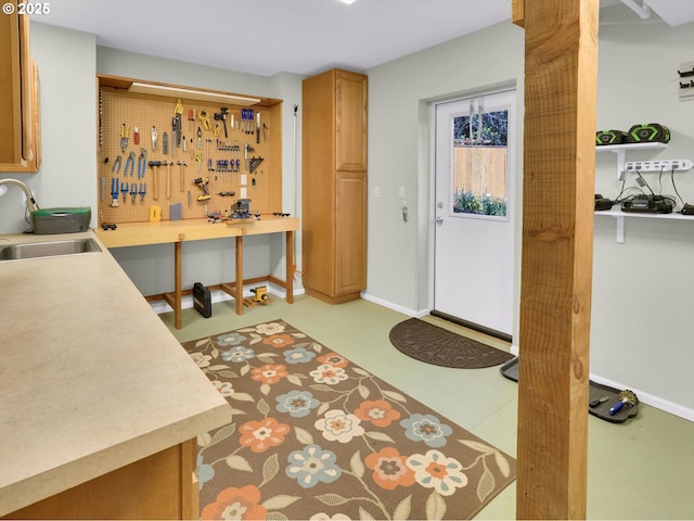 foyer entrance featuring baseboards and a workshop area