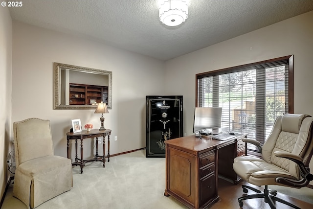 office area with light carpet, a textured ceiling, and baseboards