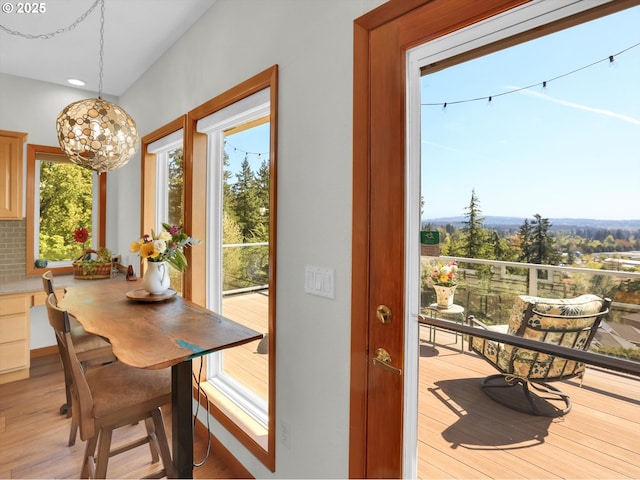 dining space featuring light wood-style floors, plenty of natural light, recessed lighting, and a chandelier